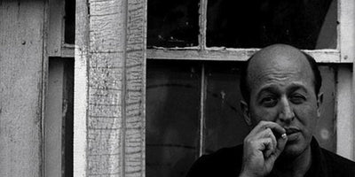 Portrait of Clement Greenberg American art critic with abstract expressionist painting background