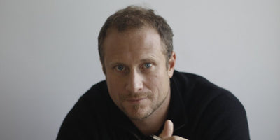 Trevor Paglen interview portrait with blurred background and artistic lighting