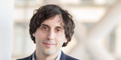 Jay Sanders at the Whitney Museum of American Art exhibition interior with visitors and artwork on display