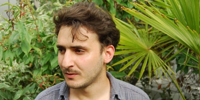 Neil Beloufa interview portrait with abstract art background