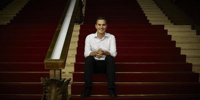 Curator Massimiliano Gioni discussing the uncanny in contemporary figurative sculpture with an abstract sculpture in the background