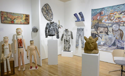 Outsider Art Fair 2016 promotional banner featuring event stories with abstract colorful artwork background