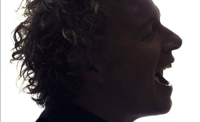 Chris Levine artist portrait with abstract light art background in vibrant colors