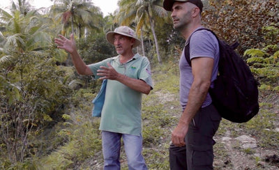 Bill claps during a speech in Cuba essay event with a blurred background