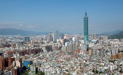 Artspace wallpaper city guide Taipei skyline with modern buildings and mountains in background