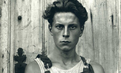 black and white photography starter kit with camera and photo prints on wooden table