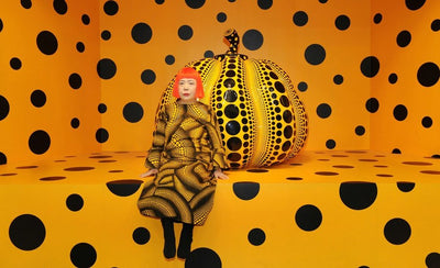 Yayoi Kusama large yellow pumpkin sculpture with black polka dots outdoors