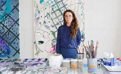 Laura Owens artist portrait with colorful abstract painting background