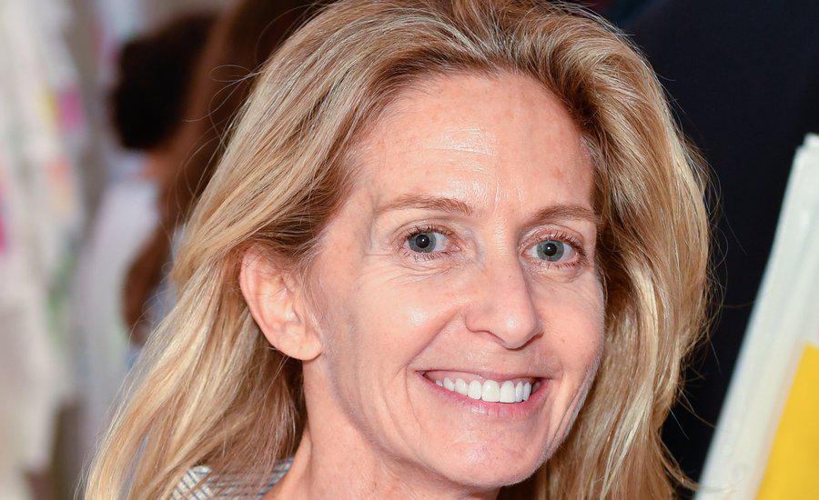 liz hopfan smiling portrait with blurred outdoor background