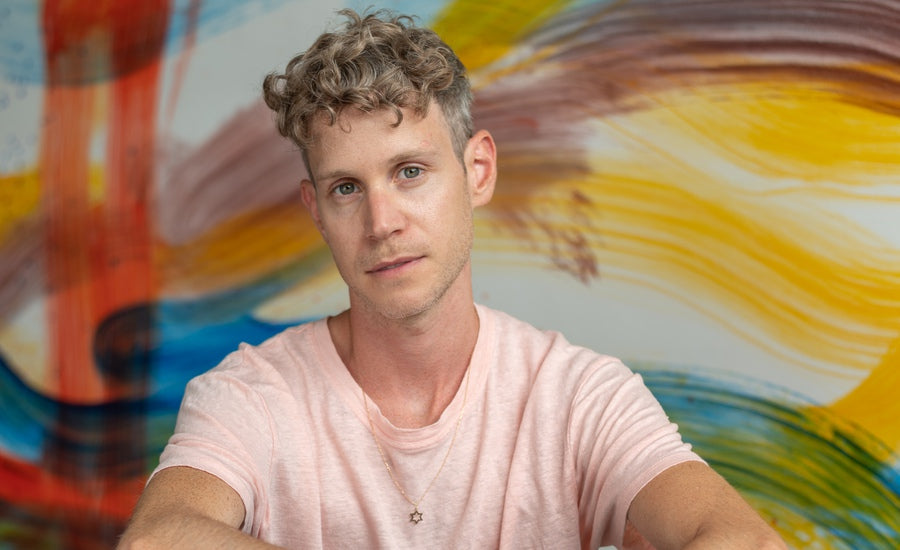 Portrait of Doron Langberg artistically painted with vibrant colors symbolizing queerness and casual expression