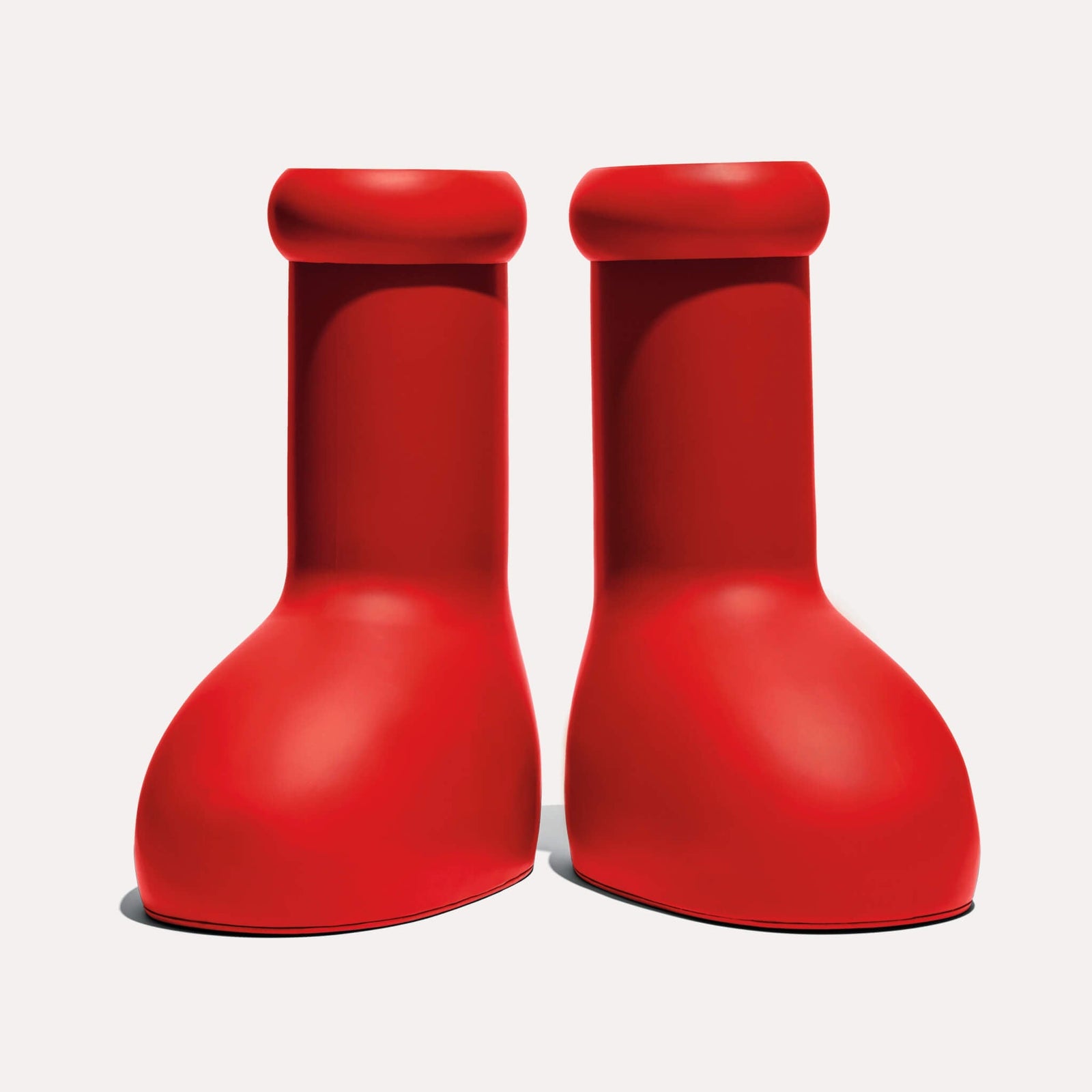 red rubber boots with a glossy finish on a light background