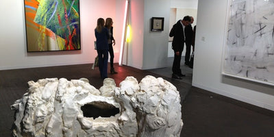 7 unmissable works at Art Basel displayed in a gallery setting with vibrant artwork and visitors viewing the exhibits