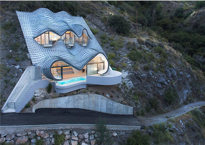 cliffside view with new lead climbing gear on rocky terrain under clear sky