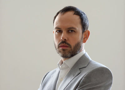 portrait of William Hall in formal attire with a neutral background