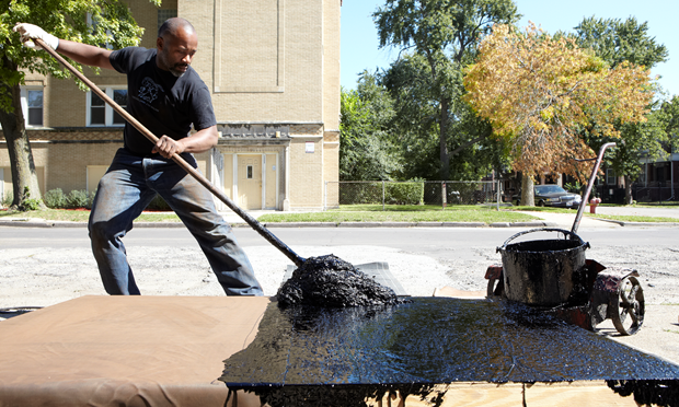 Theaster Gates creating one of his tar paintings, Chicago, 2012.