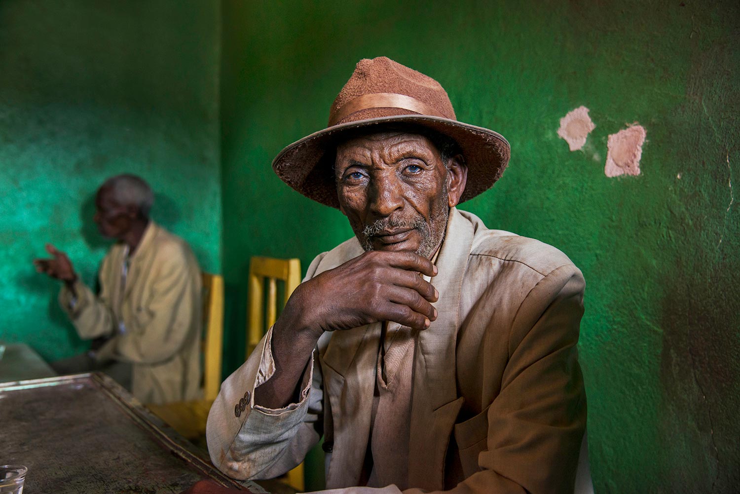 Portrait of an elderly man sitting in a green room, Ethiopia, 2014