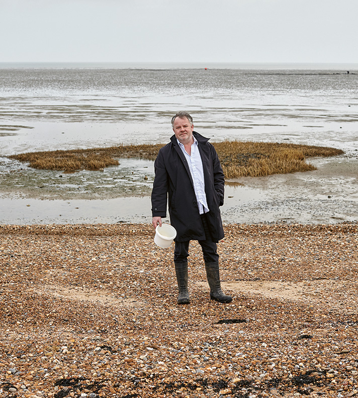 Chef Stephen Harris collects ingredients along the coastline beside The Sportsman. Photo: Toby Glanville
