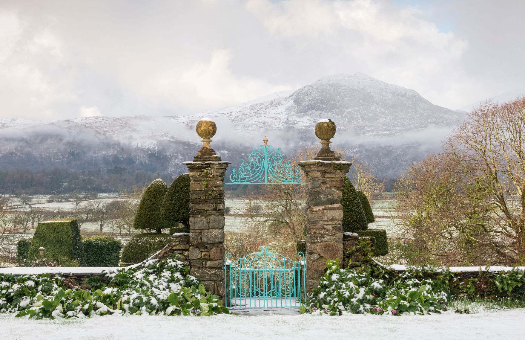 Borrowed Landscape. The garden at Plas Brondanw, Llanfrothen, Gwynedd, in Wales, UK, with a view of Snowdonia. Open to the Public.