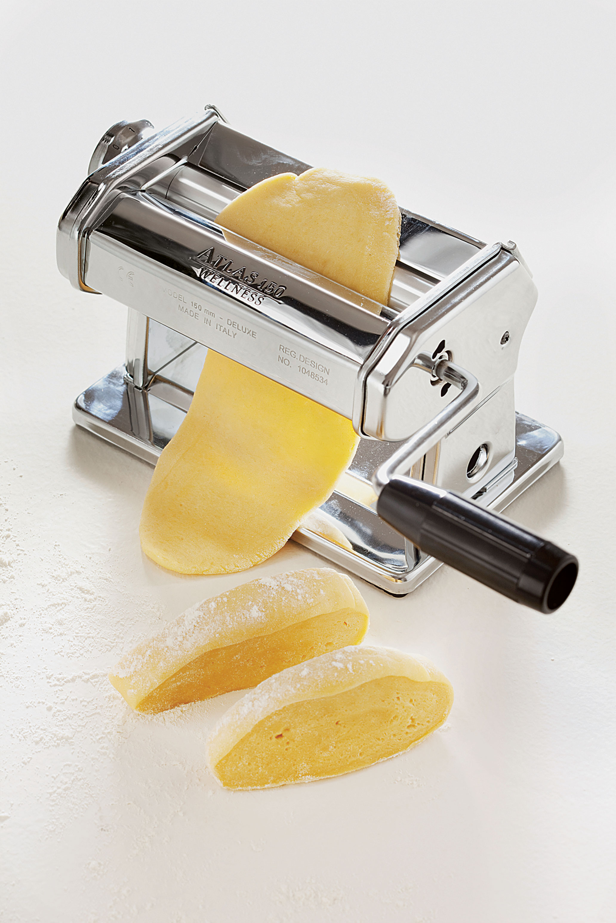Fresh egg pasta being made in a pasta machine, as featured in The Silver Spoon Classic
