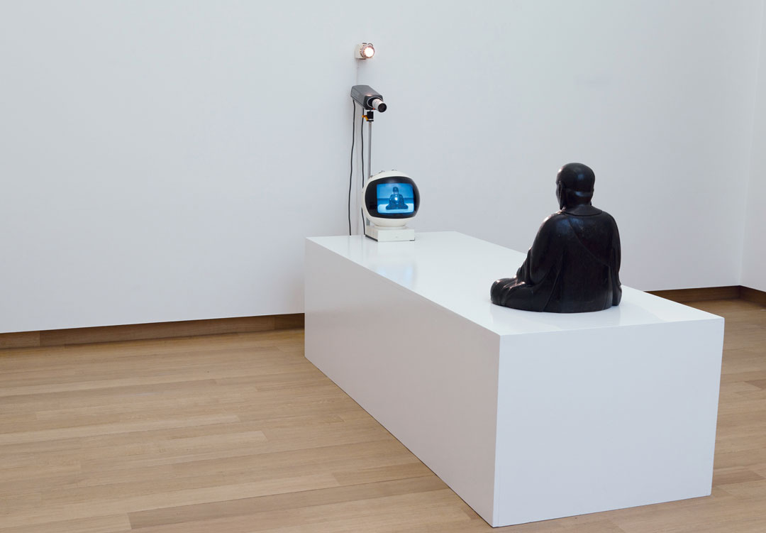 Nam June Paik, TV Buddha, 1974 Closed-circuit video installation, with eighteenth-century Buddha statue. As reproduced in Video/Art: The First Fifty Years