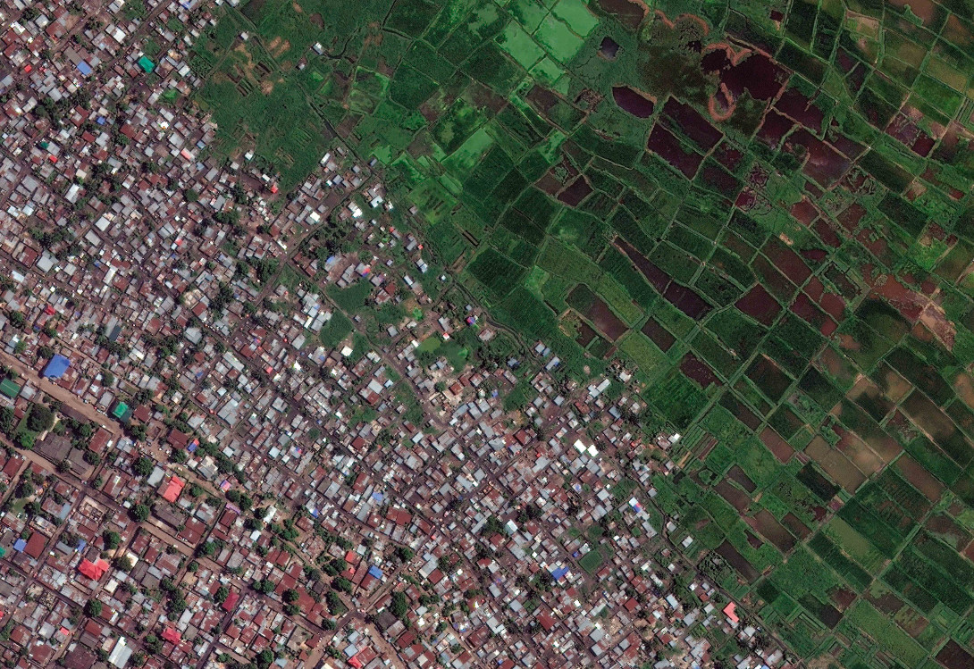 Kinshasa, Democratic Republic of Congo. In areas where land is cheap and unregulated, informal 
 development encroaches on the countryside that surrounds growing urban centres. As in many parts of rapidly urbanizing Sub-Saharan Africa, the edges of Kinshasa are being eroded as the city expands horizontally without regulation.