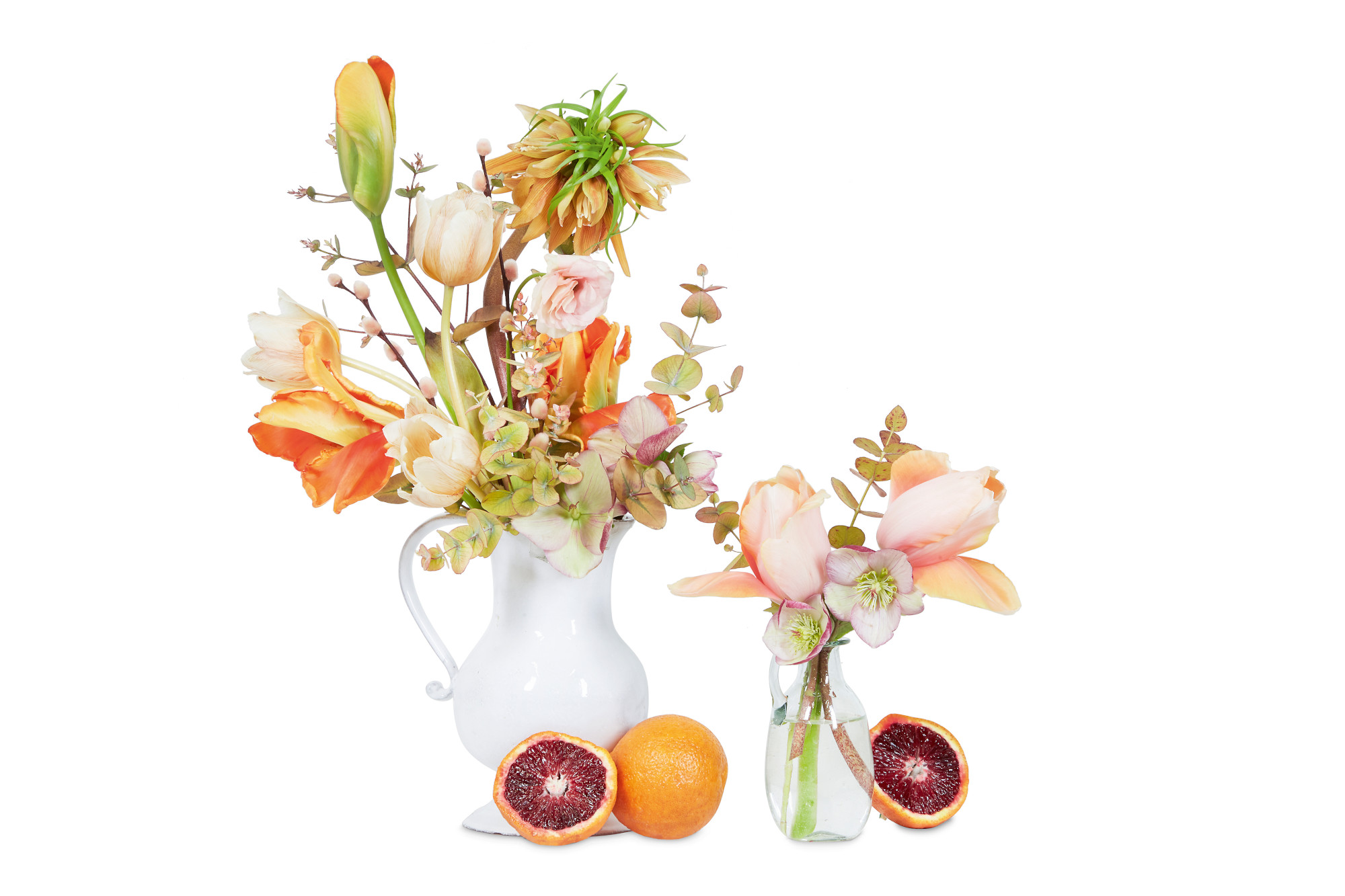 Accent Color: Orange, brown, and peach with burgundy accent. Crown imperial fritillary, Tulip, Blood orange, Ranunculus, Eucalyptus, Pussy willow. Employing vessels made of different materials, like glass and ceramic here, adds texture to a composition
