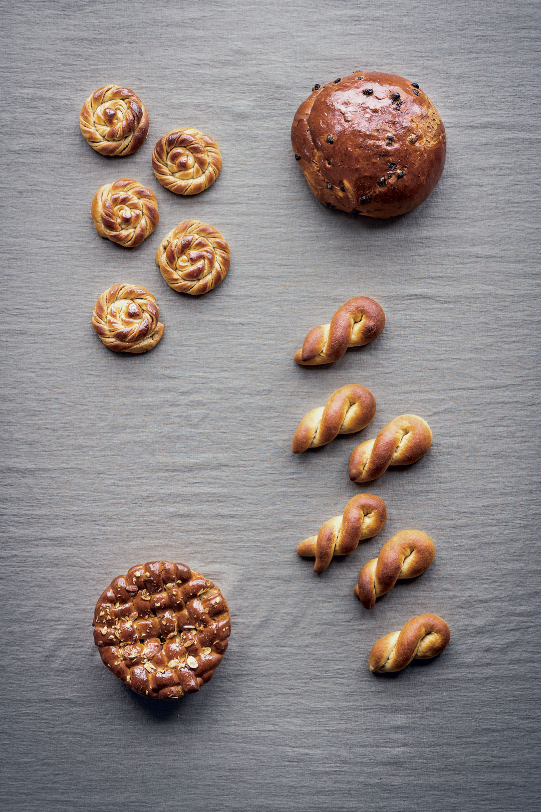 Clockwise from top left: Karlsbader Buns with Almond Paste Filling; Norwegian Christmas Bread; Boys; Danish Almond Tart Leavened with Yeast. All images by Magnus Nilsson from The Nordic Baking Book