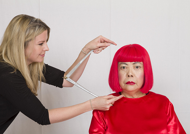A Madame Tussauds employee takes measurements for the new Yayoi Kusama zone.