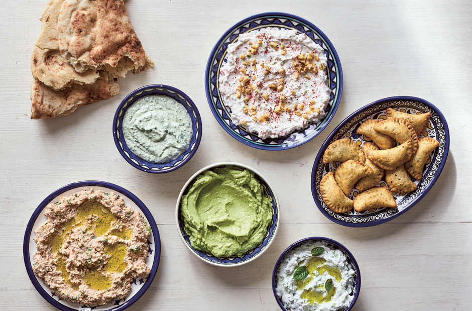 Dips and Small Bites: clockwise from left: Taboon Bread; Parsley or Cilantro (Coriander) Tahini Spread; Walnut and Garlic Labaneh; Deep-Fried Cheese and Za’atar Parcels; Garlic and Cucumber Labaneh; Avocado, Labaneh, and Preserved Lemon Spread; Labaneh And Bulgur Spread
