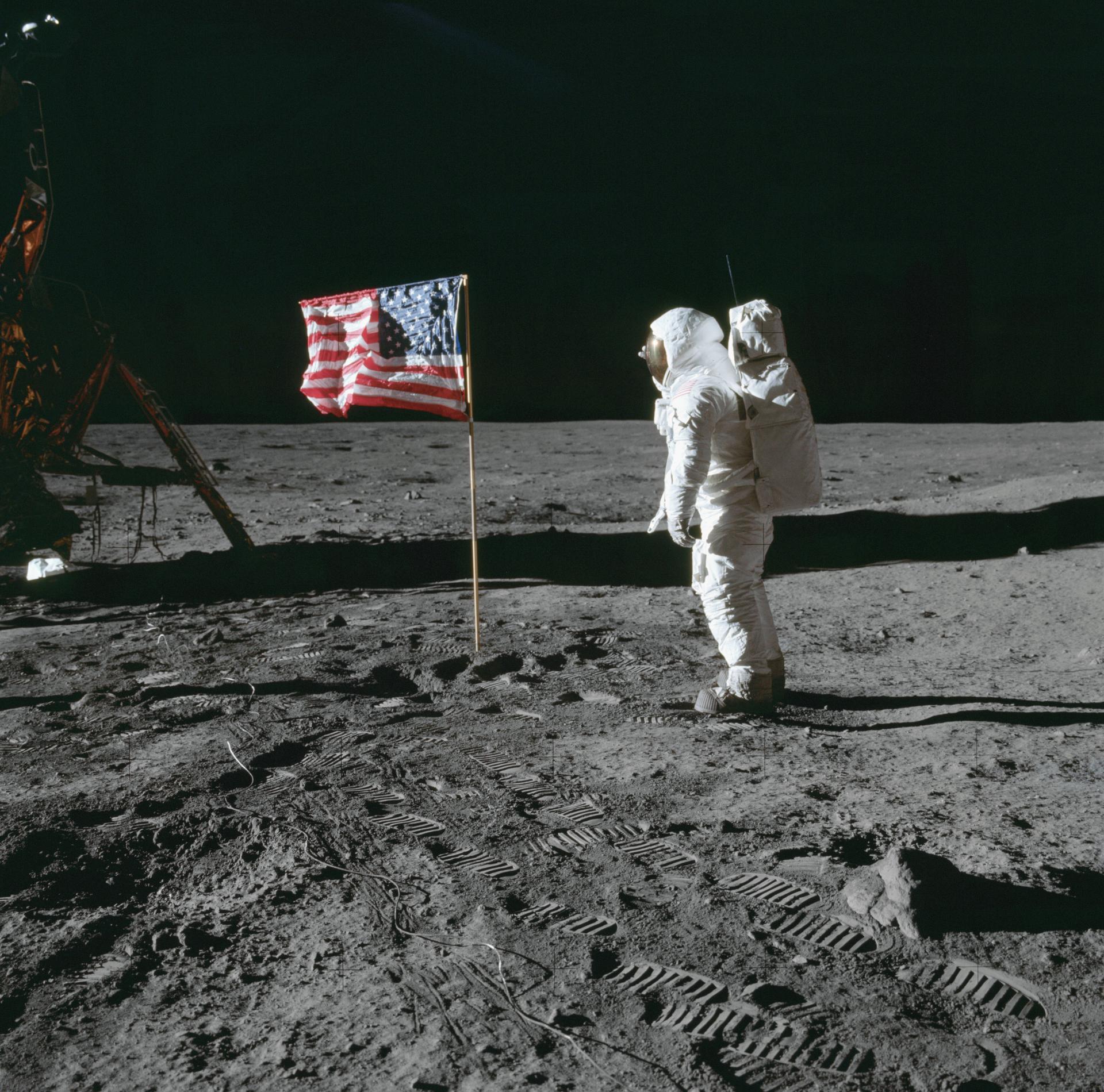 Astronaut Edwin E. Aldrin Jr., lunar module pilot of the first lunar landing mission, poses for a photograph beside the deployed United States flag during Apollo 11 extravehicular activity (EVA) on the lunar surface. Image courtesy of NASA