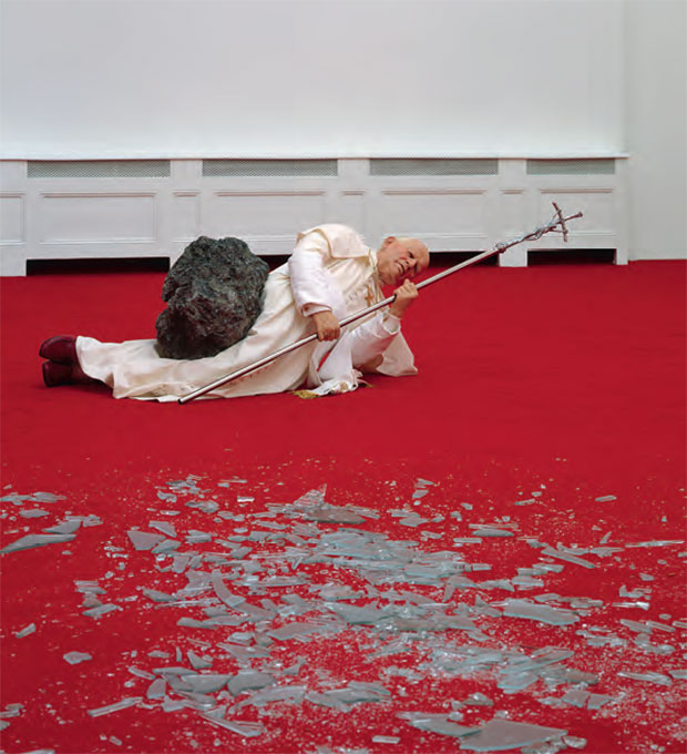 Maurizio Cattelan, La Nona Ora, 1999, wax, clothing, polyester resin with metallic powder, volcanic rock, carpet and glass, dimensions variable SALE 17 May 2001, New York ESTIMATE $400,000–$600,000/ £281,000–£421,400 SOLD $886,000/£622,325
