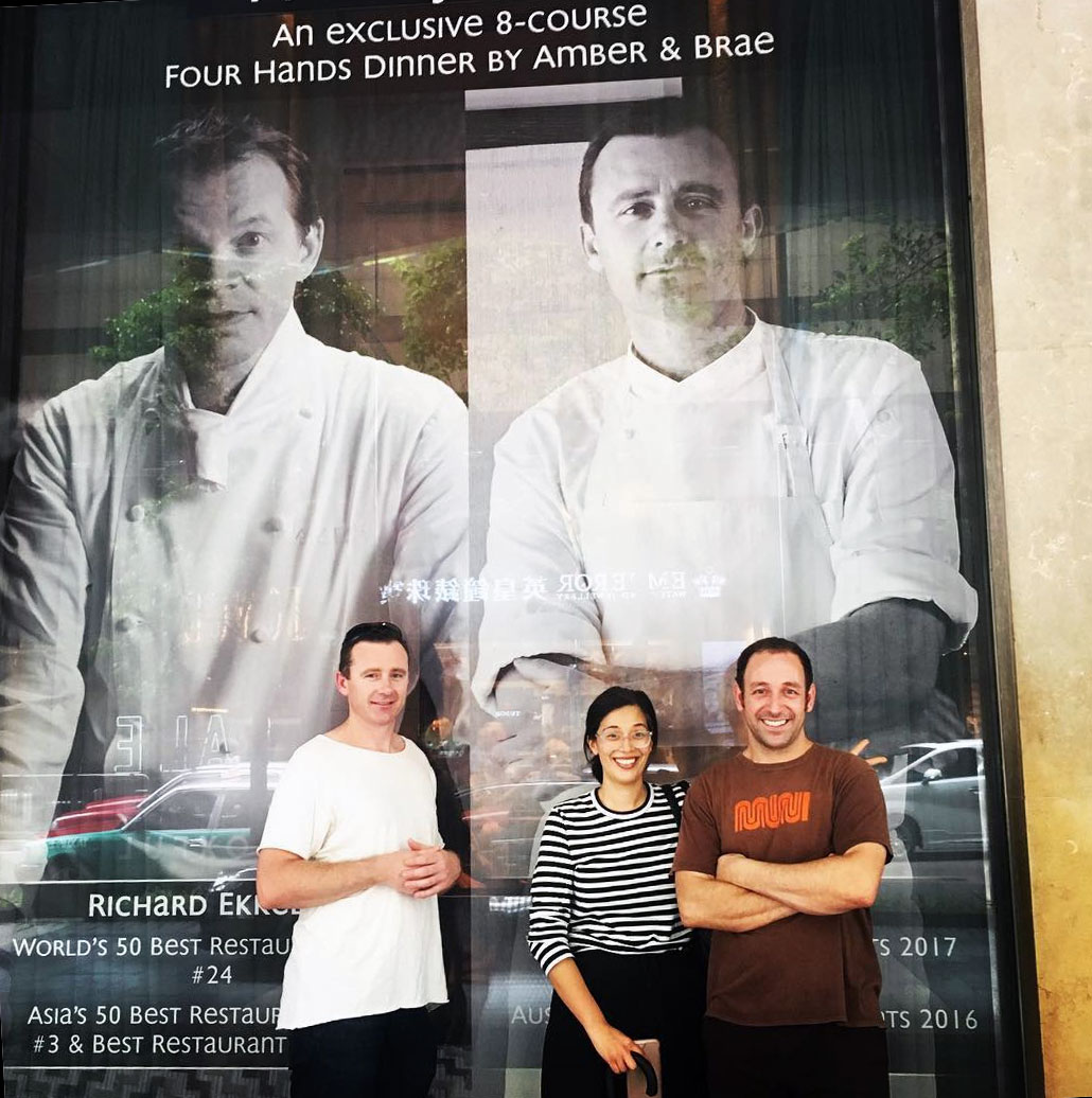 Dan stands beside a window display promoting his Amber dinner with Richard Ekkebus in Hong Kong. Image courtesy of Dan's Instagram