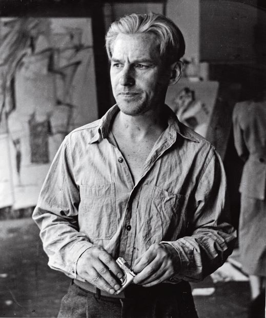 Willem de Kooning en su estudio de la Cuarta Avenida con dibujos relacionados con la mujer que en el fondo, de 1950;  fotografía de Rudy Burckhardt.  Obra de Willem de Kooning © 2014 La Fundación Willem de Kooning / Sociedad de Artistas Derechos, (ARS), Nueva York