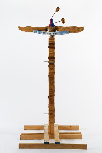 Jimmie Durham, Choose Any Three, 1989. Carved and painted wood, metal, and glass, 99 3/16 × 49 3/16 × 48 in. (251.9 × 124.9 × 121.9 cm), kurimanzutto, Mexico City. Courtesy the artist and kurimanzutto, Mexico City. © Jimmie Durham. Photograph by Jean Christophe Lett
