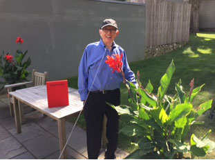Ellsworth Kelly with the new book, in his garden, Spencertown, NY, 2015