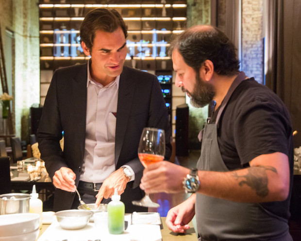 Roger Federer takes tips from Enrique Olvera on how to make scallop aguachile. Photograph by Ben Lozovsky for Moët & Chandon