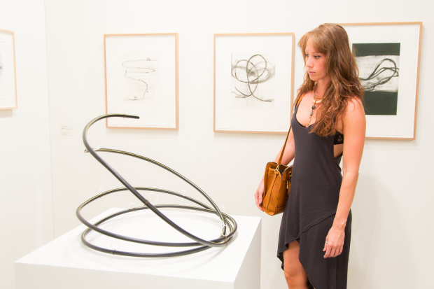 A visitor takes in an Al Taylor sculpture at the Borch Jensen, Art Basel Miami Beach 2013
