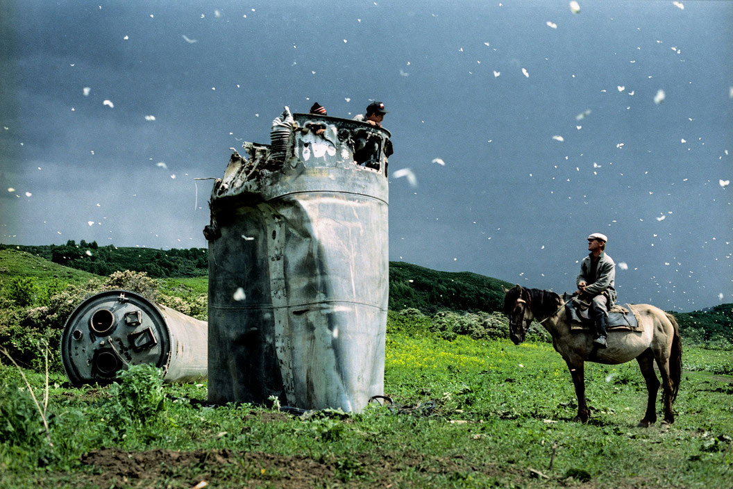 Altai Territory, Russia, 2000. Villagers collecting scrap metal from a crashed space rocket, surrounded by thousands of butterflies by Jonas Beniksen