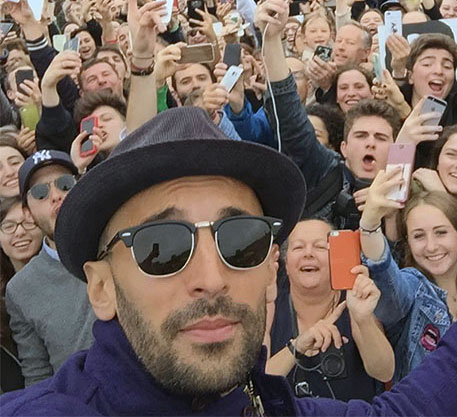 JR outside the Louvre, Paris, with fans
