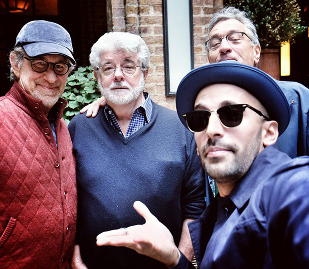 JR (sunglasses, near right) talking art and ideas with Steven Spielberg, Georges Lucas and Robert De Niro. (The artist says De Niro photobombed the pic!)