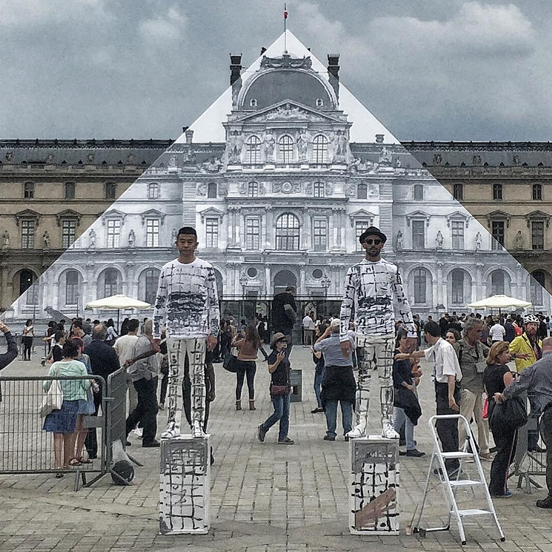 JR and Liu Bolin beside the Louvre Pyramid
