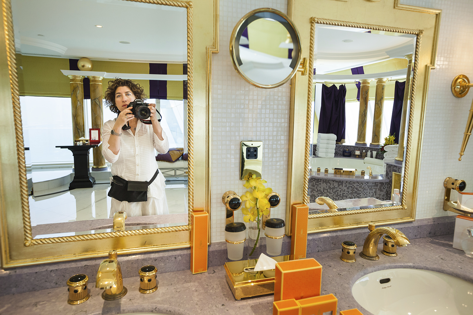 Lauren Greenfield catches herself in the mirror in the Presidential Suite at the Burj Al Arab hotel, Dubai, UAE, 2009. A still from Generation Wealth