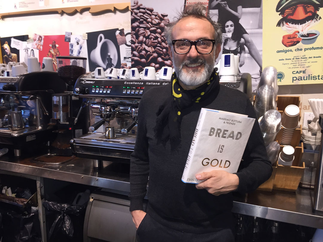 Massimo Bottura with a copy of his book in Eataly, New York City - photo Mat Smith