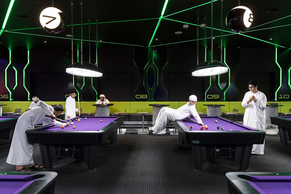 Hub Zero, Dubai, January 2017. Emirati boys playing a game of pool at Hub Zero, an immersive entertainment hub located at City Walk shopping mall. © Nick Hannes. Documentary Series Winner, Magnum and LensCulture Photography Awards 2017