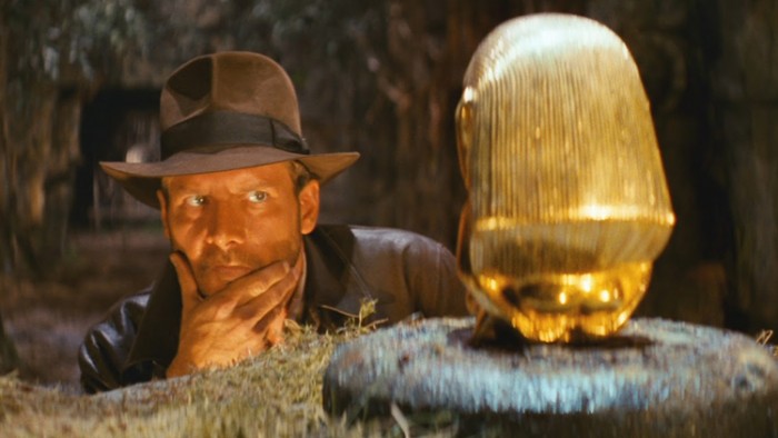 Indiana Jones with the gold replica of the 'Aztec birthing figure' from Raiders of the Lost Ark (1981)