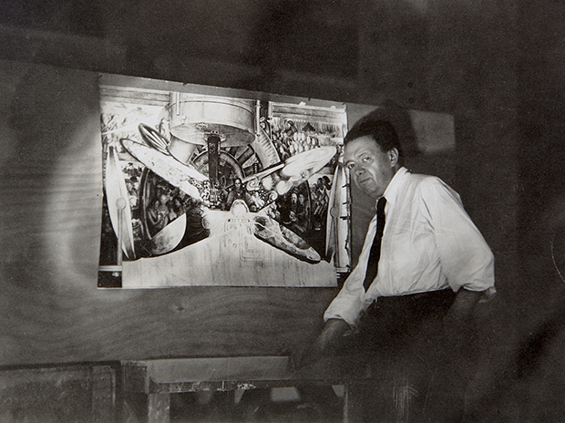 Diego Rivera with a photograph of his destoryed Rockefeller Center work, c. 1933