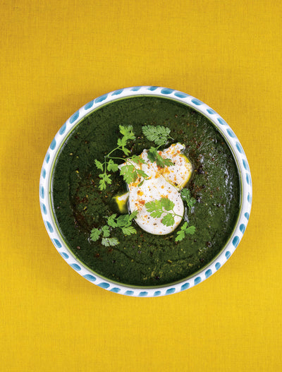 Ed Sheeran performing live with microphone and guitar on stage