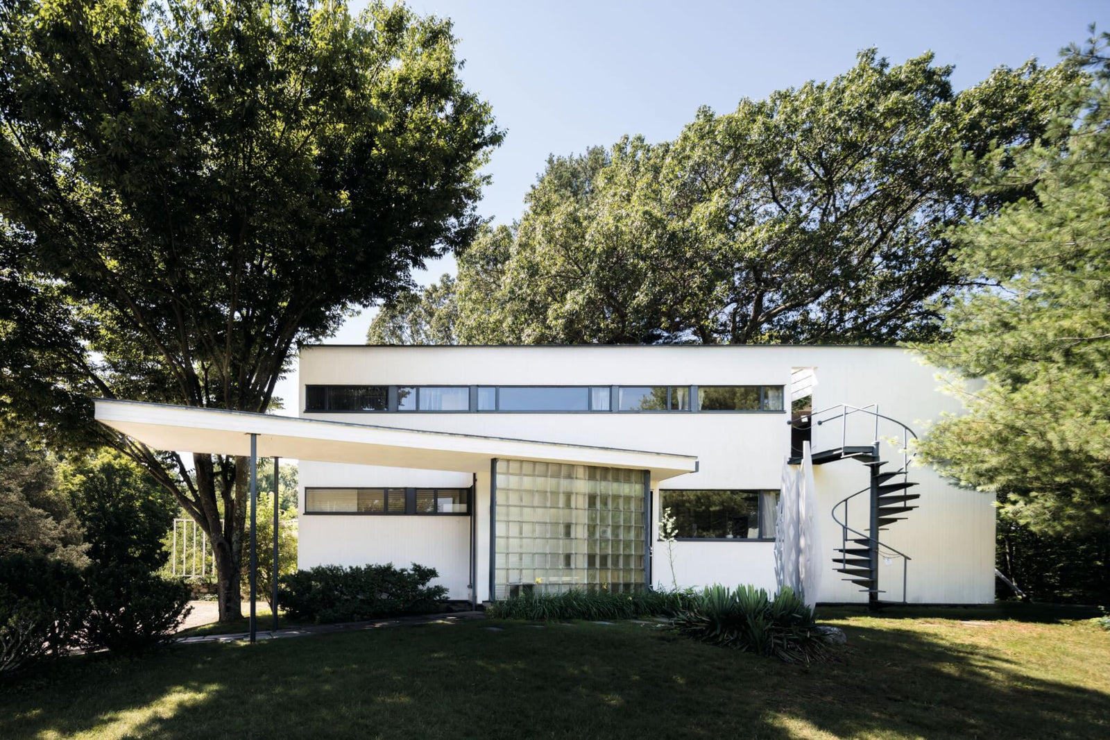 Gropius House modernist architecture exterior with large windows and flat roof surrounded by trees