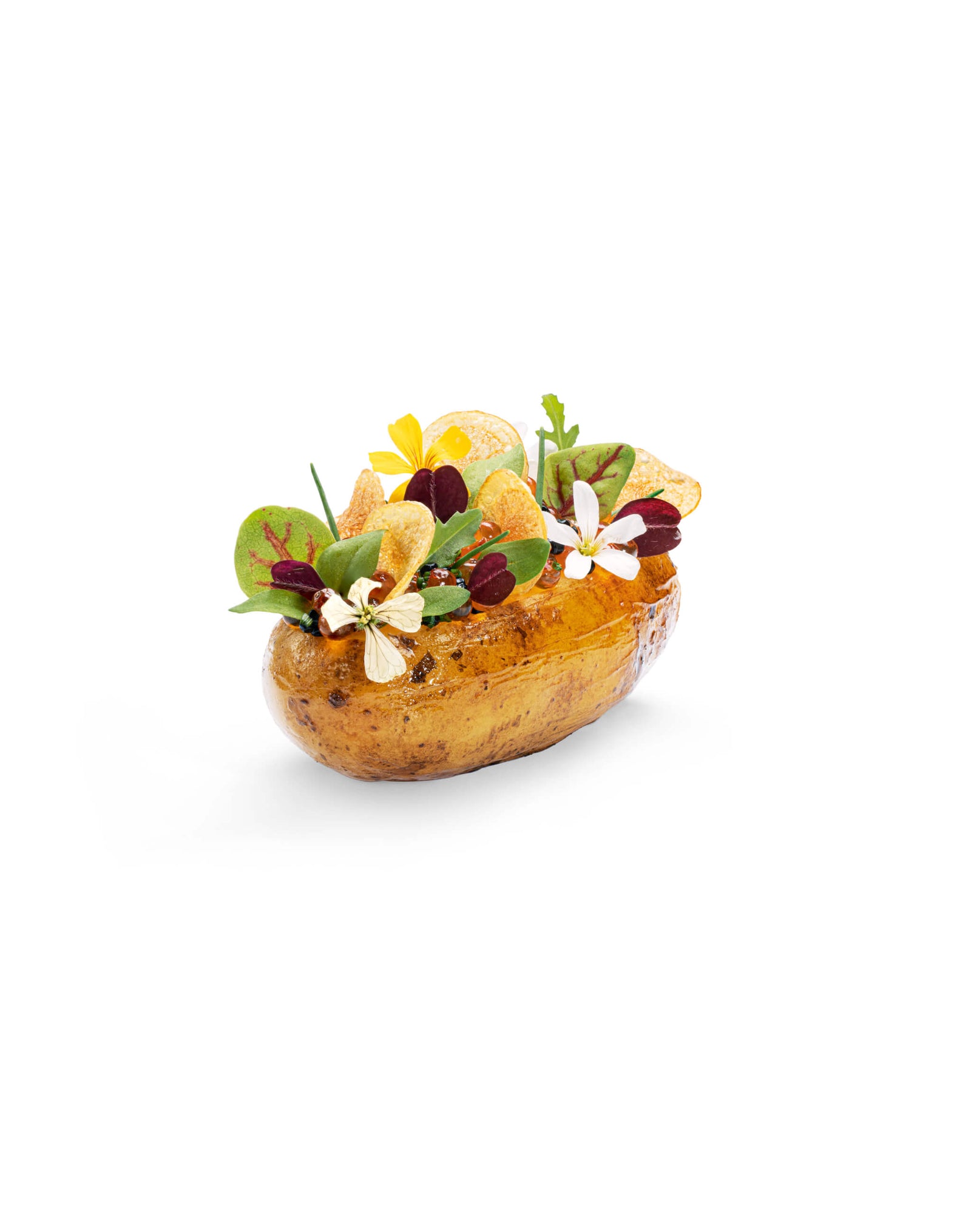 decorative edible art featuring a baked potato filled with vibrant edible flowers and fresh greens on a white background