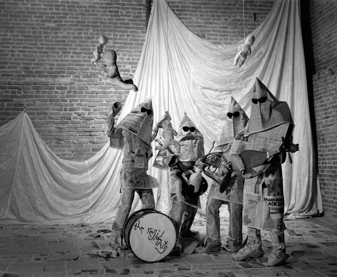 The Residents band members performing on stage with masks and costumes